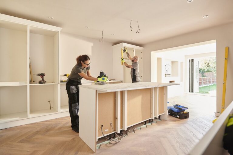 two tradespeople working on a capital improvement kitchen remodel