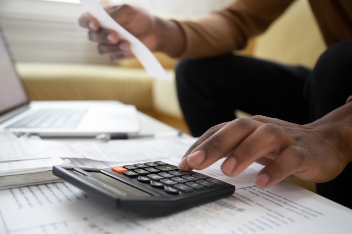 Landlord using a calculator to add up fees to include in a rent receipt