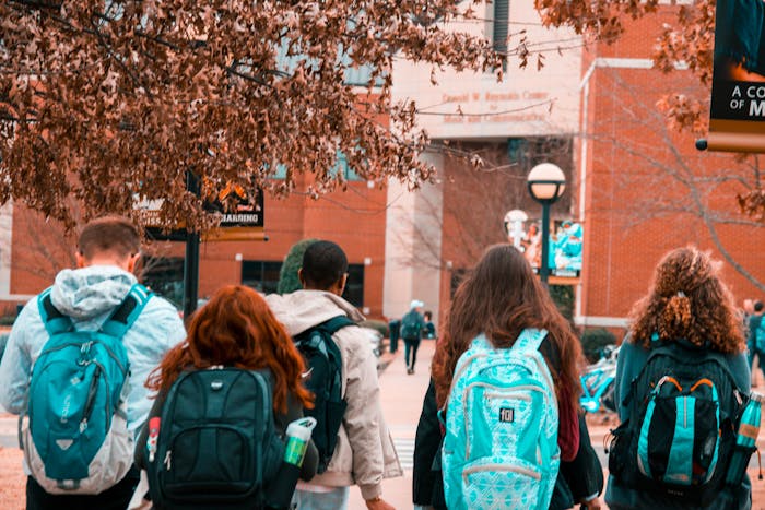 Students with backpacks on walking into class